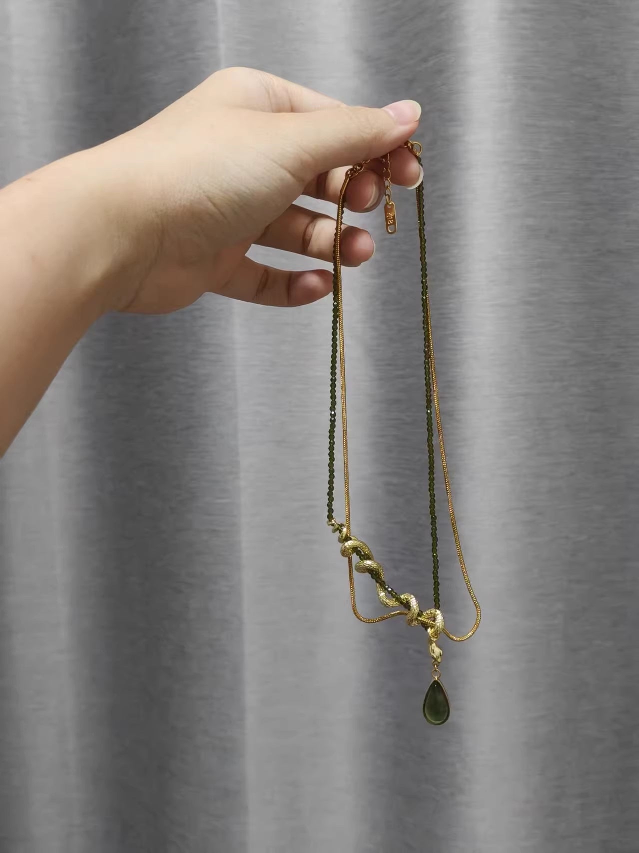Thalia- Pear Cut Green Peridot Unique Serpent Shape Necklace