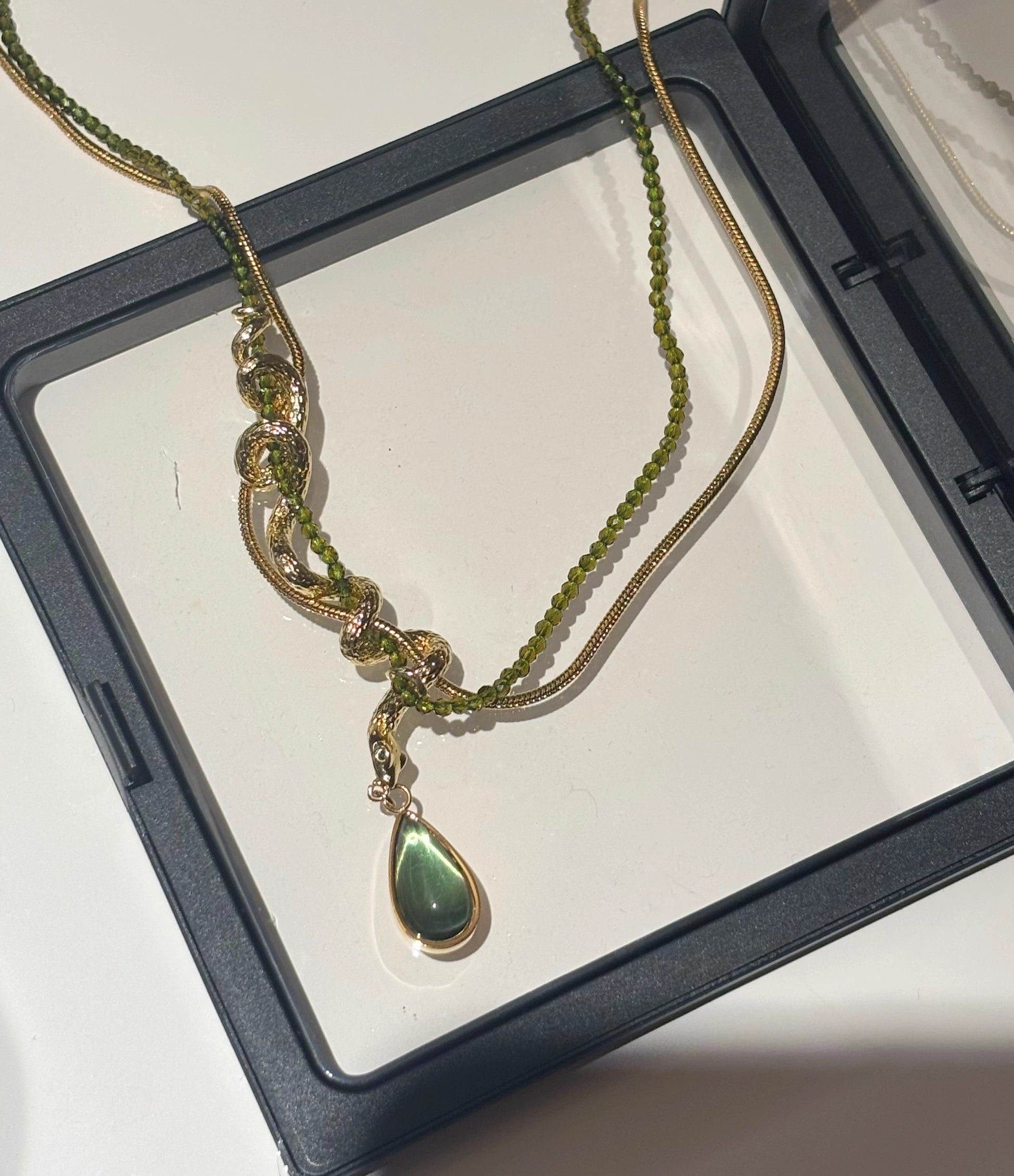Thalia- Pear Cut Green Peridot Unique Serpent Shape Necklace